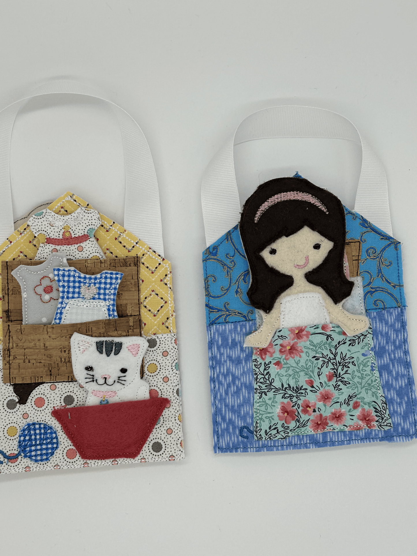 Felt and cloth "paper style" doll in cloth bed with wardrobe and cat